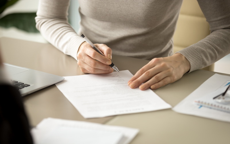 Woman signing document